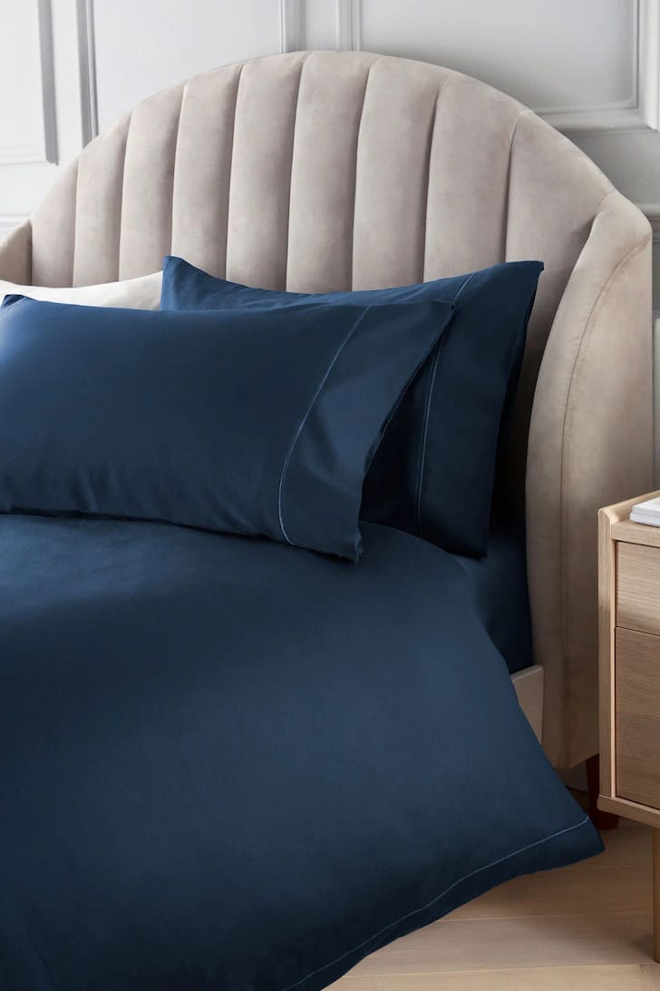 dark blue cotton bedding set king size on bed
