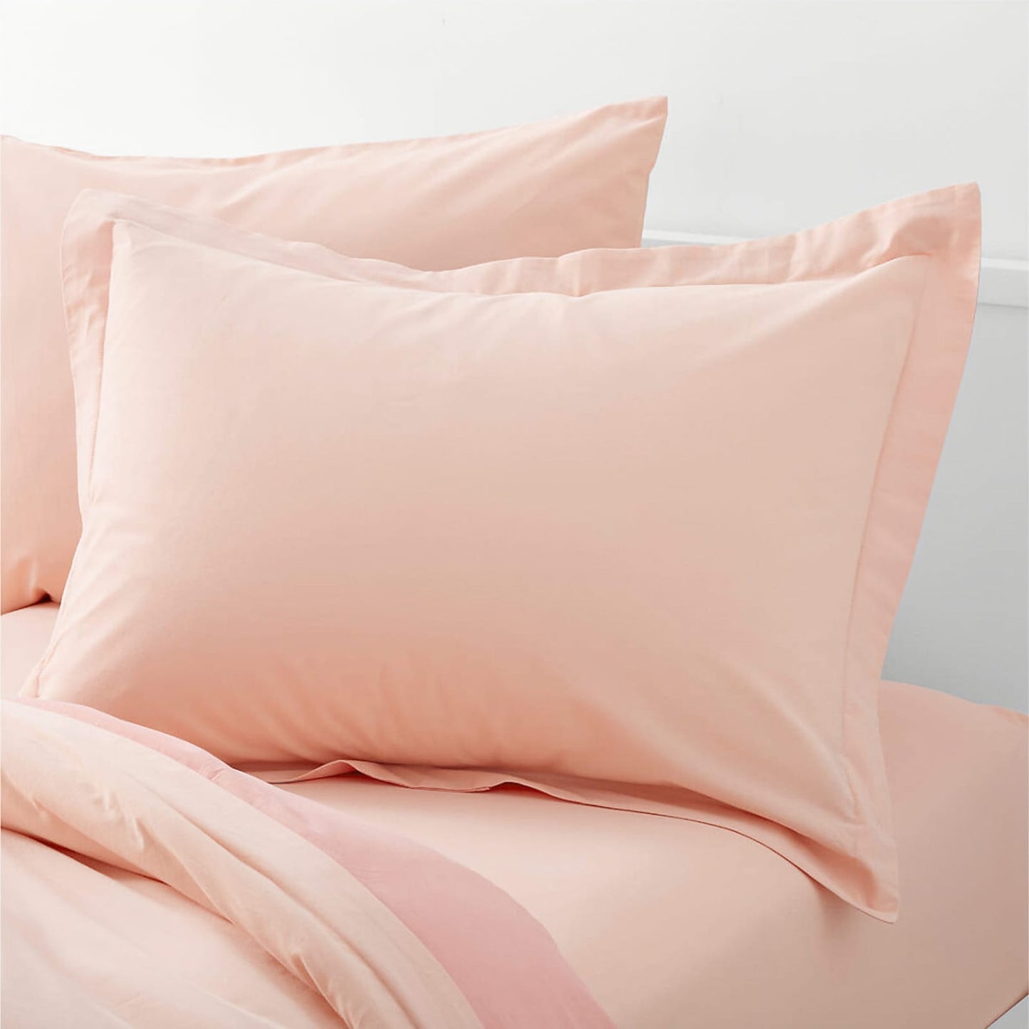 peachy pink pillow casses on pillows