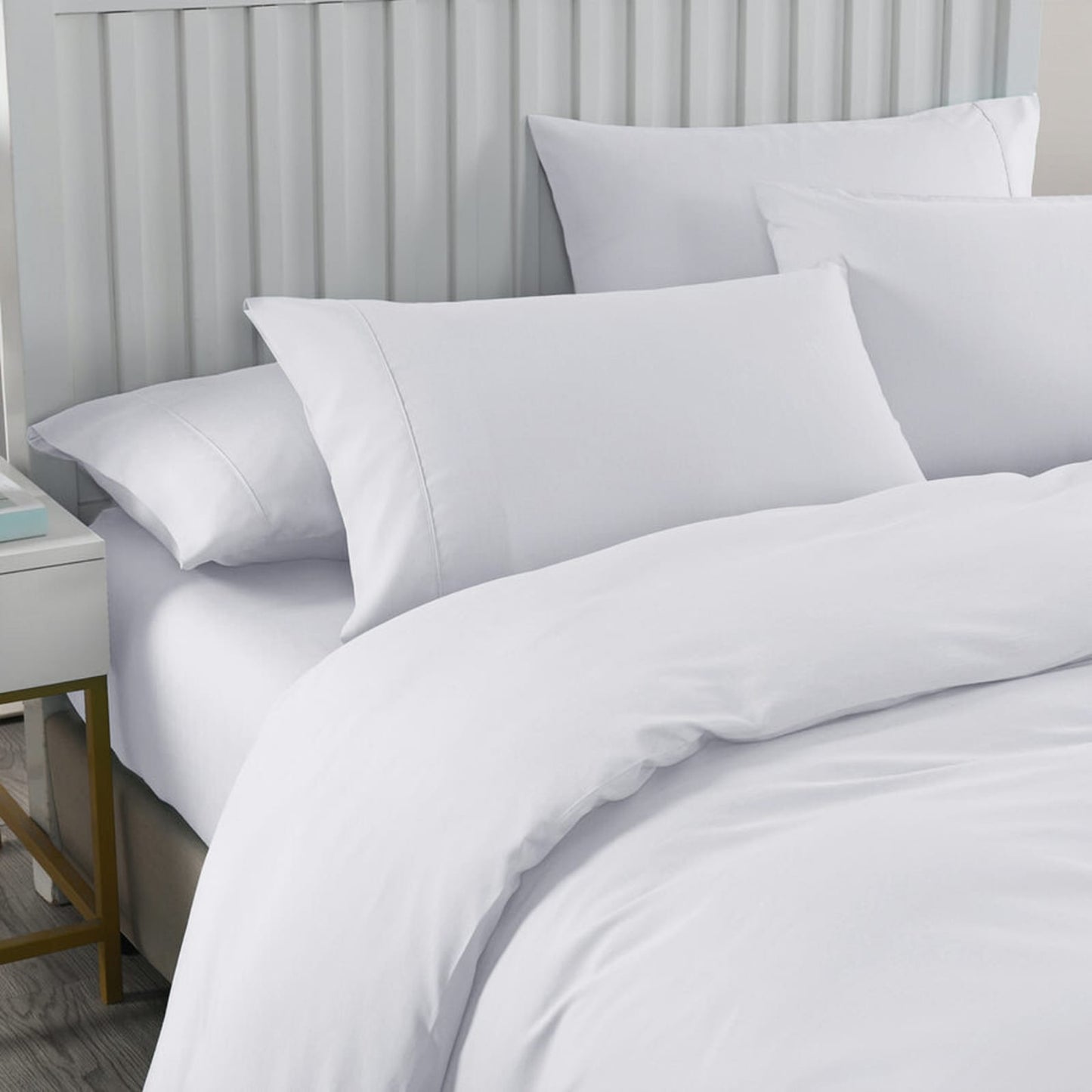 white cotton bedding set on bed