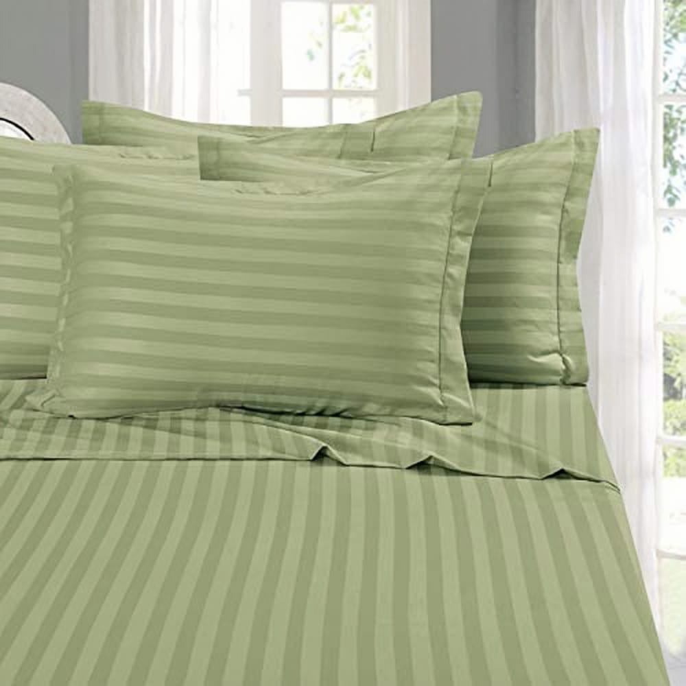 green olive pillow casses on pillow with stripes on bed
